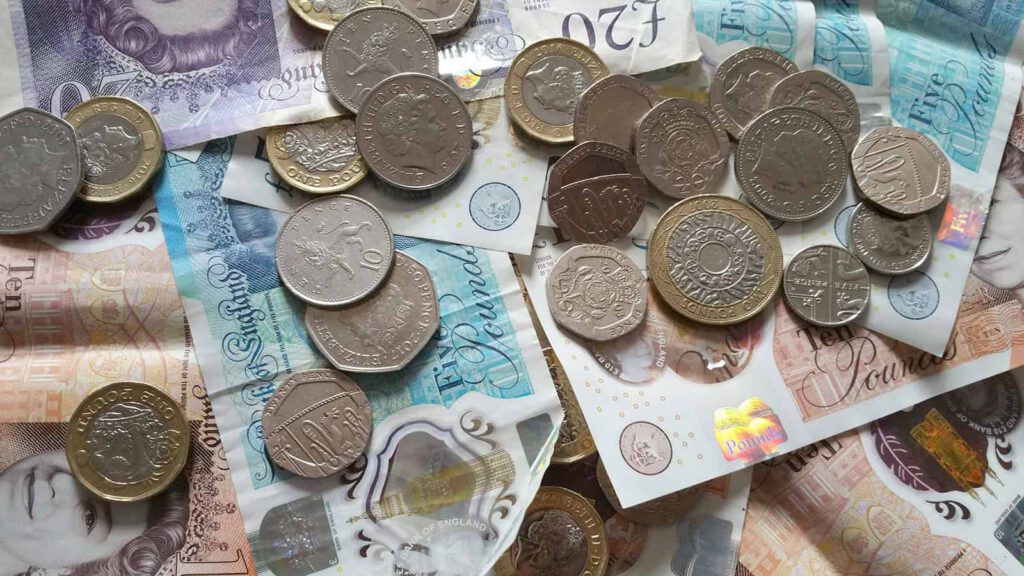 British money scattered on a table to illustrate tamp duty increase and its impact on landlords